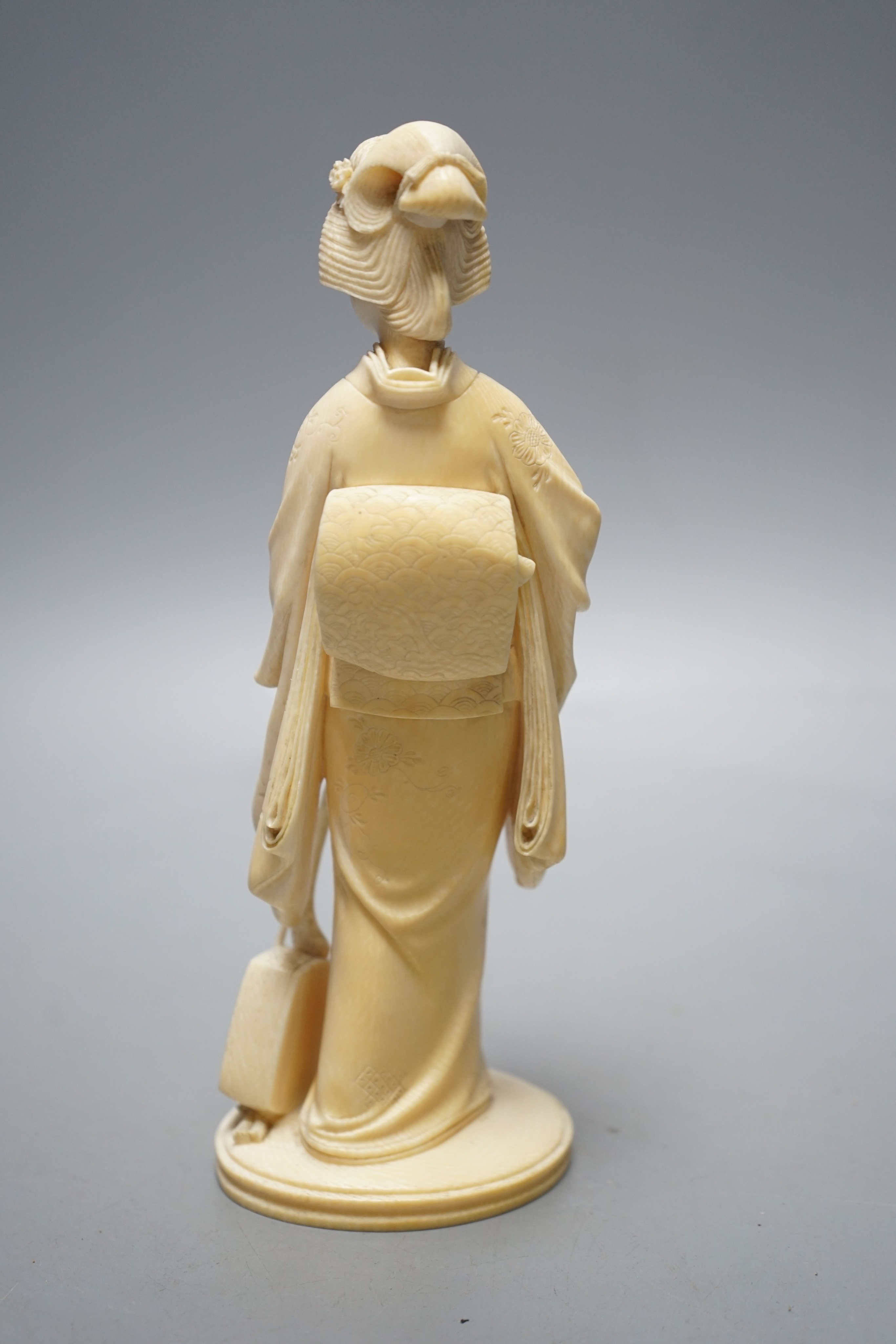 A Japanese Meiji period okimono of a lady with a musical instrument, 19 cms high.